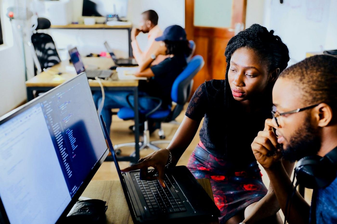 Two developers reviewing code together on screen